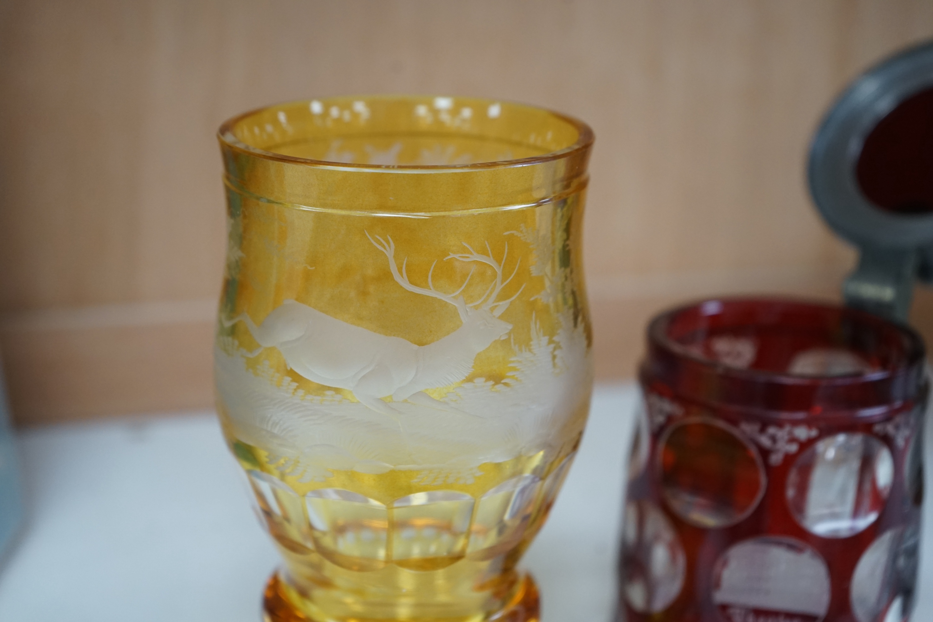 Two 19th century Bohemian glasses and a similar tankard, amber glass 15cm high. Condition - good